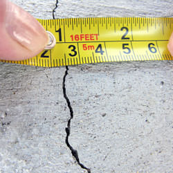 A crack in a poured concrete wall that's showing a normal crack during curing in Marshall